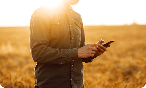 Farmer in field making a phone call